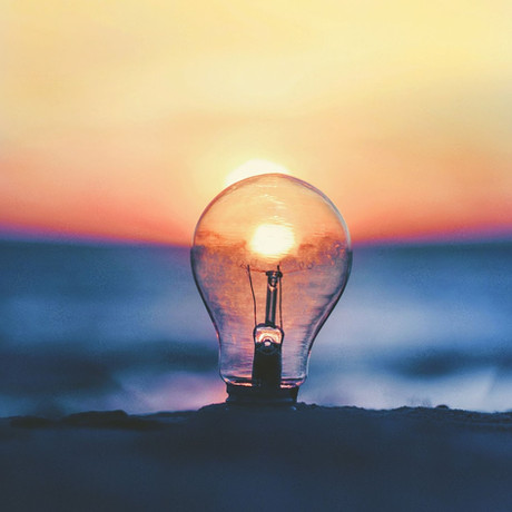 A light bulb placed against a sunset background, symbolizing creativity and new ideas.