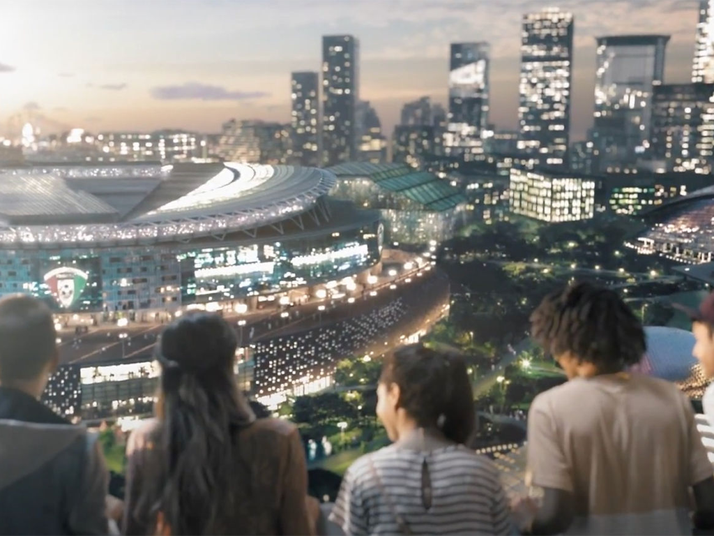 View of a stadium with a crowd in the foreground, showcasing a modern cityscape at dusk.